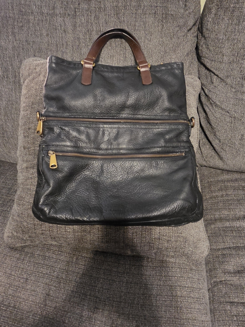Fossil Explorer black leather fold-over tote.